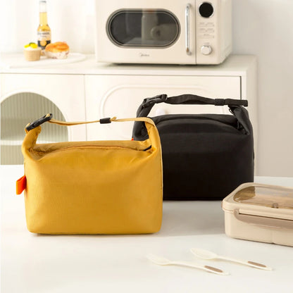Yellow and black bags on a kitchen counter with a microwave in the background