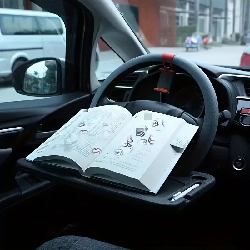 Car dashboard with a book on a stand, steering wheel visible